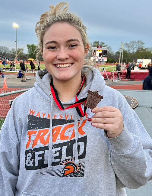 girl holding medal